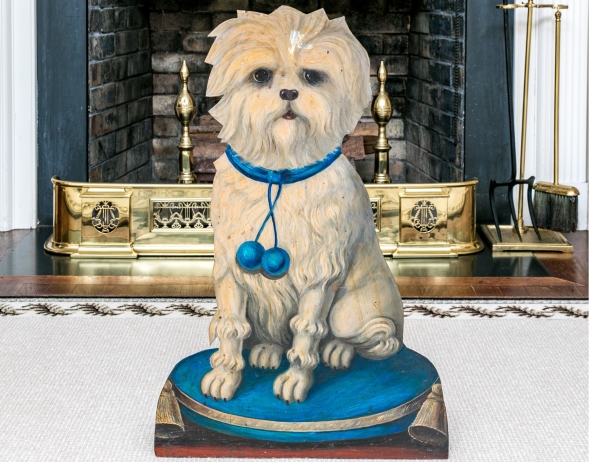 A semi-antique Tole dog-form umbrella stand featuring a cream colored dog with blue collar sitting on a blue pouf pillow with tassels | BRG