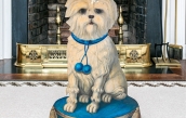 A semi-antique Tole dog-form umbrella stand featuring a cream colored dog with blue collar sitting on a blue pouf pillow with tassels  | BRG